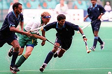 KUALA LUMPUR : Lazarus Barla (2) and Ramandeep Singh of India battle for the ball with South African Justin King from the both sides during their Commonwealth Games men's field hockey preliminary match in Pool A in Kuala Lumpur on Saturday. India defeated South Africa 2-1.