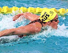KUALA LUMPUR : Petria Thomas of Australia competes in the Women's 100m butterfly at the 16th Commonwealth Games in Kuala Lumpur on Tuesday. Thomas won the gold with a time of 59:42. AP/PTI