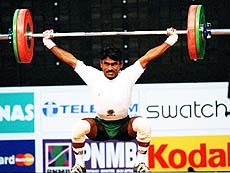 Dharmaraj Wilson of India snatched the gold by lifting 140.0 kg in the clean and jerk event and won the silver in the 56 kg weight class by lifting a total of 242.5 kg at the 16th Commonwealth Games on Thursday. AP/PTI