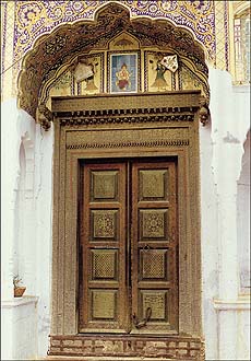 A remarkably beautiful copper-studded door structure