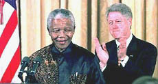 Clinton applauds South African President Nelson Mandela during a meeting with African-American religious leaders at the White House on Tuesday.