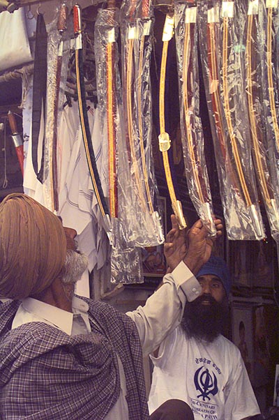 A devotee choosing a good kirpan for himself from a stall set up near Takht Sri Kesgarh Sahib on April 14, 1999