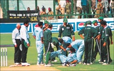 Sourav Ganguly, who was hit on the ribs by a fast delivery from Shoaib Akhtar, is helped by the team doctor and others in the India-Pakistan one-day cricket match at PCA Stadium, S.A.S. Nagar, on Thursda