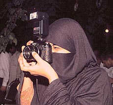 A ‘burqa’ clad Pakistani woman tries to capture the ‘bhai-bhai’ mood of the evening at the Rock Garden in Chandigarh on Friday evening.