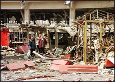 Residents survey the damage at the main bus station in Pristina
