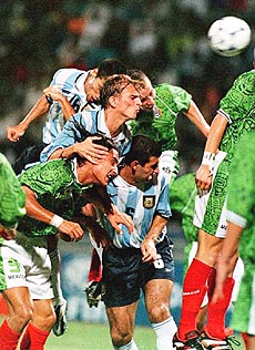 Mexican and Argentinian players scramble to head a ball to teammates during the first half of a match of the second round of the 10th Youth World Cup in Ibadan on Thursday