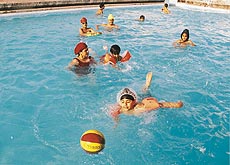 Kids enjoy a game of water polo at Chandigarh Club swimming pool on Monday.