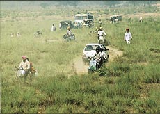Vehicles forced to take to the dry bed of a choe.