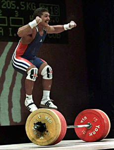 Cuba's Hidalberto Aranda reacts after seting a new World Record when he lifted 205.5 kg in the clean and jerk portion for up to 77 kg during the weightlifting tournament of the XIII Pan Amemrican Games, Thursday, Aug. 5, 1999 in Winnipeg, Manitoba, Canada