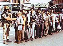BSF personnel frisk pedestrians at Lal Chowk in the heart of Srinagar as the Independence Day approaches