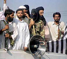 Armed supporters of Saudi dissident Osama Bin Laden guard the anti-United States rally on Friday, Aug 13, 1999 in Lahore. Partcipants are chanting slogans in favour of Laden, who is wanted by United States government claiming his involvement in bombings of American embassies in Nairobi and Tanzania. Laden is hiding in Afghanistan.