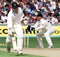 England wicketkeeper Alec Stewart breaks the bails in an attempted run out, during the first day of the 4th Test at the Oval in London on Thursday