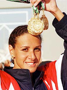 Egyptian swimmer Rania Alwani carries the 10 gold medals she has won over the past week at the Arab Games