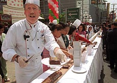 Hans Peter Kaserer of Salzburg, Austria, an executive chef of a hotel in Bangkok, offers a piece of brownie