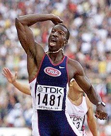 Michael Johnson of the United States celebrates after winning the gold medal in the Men's 400 meters in a new world record time of 43.18 at the seventh World Track and Field Championships in Seville's Olympic Stadium on Thursday