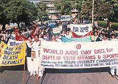 Carrying placards and banners, students hold an awareness rally on World AIDS Day in Chandigarh on Wednesday