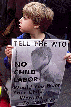 A boy holds a sign opposing child labour during an anti-World Trade Organisation demonstration in downtown Seattle on Friday. The demonstration was peaceful.