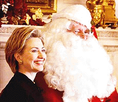 First lady Hillary Rodham Clinton poses with Santa Claus, an unidentified Secret Service agent, at the White House on Monday during a media tour of the White House holiday decorations