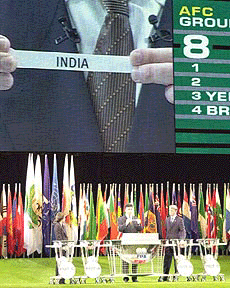 A white ribbon written with India is shown on the screen as FIFA General Secretary Michel Zen-Ruffinen of Switzerland announces a preliminary draw for Asia Group 8 in the 2002 World Cup Korea/Japan during a drawing ceremony in Tokyo on Tuesday