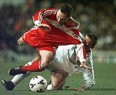 Leed's Alan Smith (right) brings down Spartak's Moscow's Evgeni Bouschmanov during their UEFA Cup, third round second leg match, at Elland Road Leeds, England on Thursday