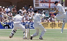 England's Chris Adams, right, leaps out of the way of a shot hit for four by South Africa's Mark Boucher, on the second day of the second Test Match between England and South Africa at the St George's ground in Port Elizabeth, South Africa, Friday. England wicketkeeper Alec Stewart is at centre