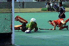 Indian goalkeeper Tingonleima trying to foil the attack of South Korean forward Seong Eonkin in the final of the Asia Cup Hockey tournament at National stadium on Friday