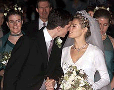 Britain's tennis star Tim Henman kisses his bride Lucy Heald as they leave the church, after their marriage in Odiham, southwest of London on Saturday