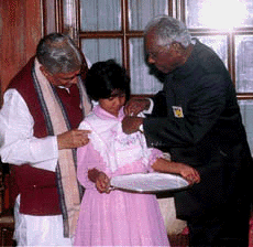 President K. R. Narayanan pinning UNICEF badge to a child after he inaugurated the UNICEF gretting card winter campaign for the new millennium at a function in New Delhi on Monday