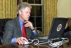 President Clinton joins the holiday Internet wave as he shops online from his desk in the Oval Office of the White House on Monda