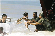 Sailors carry a baby