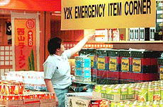 A Singaporean shop assistant retrieves a packet of portable cooking gas casettes for a customer at the Daimaru shopping center in Singapore on Wednesday