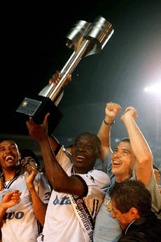 Rincon of the Corinthians team raises the trophy along with Luizao (right) and Nene (left) after winning the Brazilian national soccer championship against Club Atletico Mineiro at the Morumbi stadium in Sao Paulo, Brazil on Wednesday
