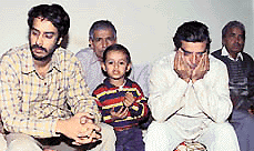 A brother (extreme left) and father (with hands covering his face) of Mr Rakesh Kataria sit crestfallen at their Mani Majra residence on Sunday as they had no news about the welfare of Rakesh and his wife, Puja.