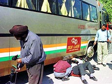 Bomb experts from Punjab Police inspect the Delhi-Lahore bus at Amritsar on Friday.