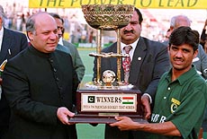 Pakistan Prime Minister Nawaz Sharif, giving away winners trophy to Atif Bashir, captain of Pakistan hockeyteam