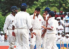 Indian bowler Harbhajan Singh (centre) celebrates with teammates 
