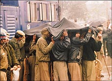 Strike by bakers capped by torrential rains put policemen to a lot of inconvenience on Wednesday. Police personnel had to resort to such innovation to save themselves from the heavy downpour. 