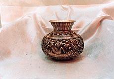An intricately designed silver vase