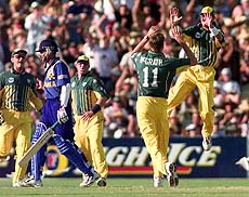   ADELAIDE : Greg Blewett (far right) leaps in the air as he congratulates Australian bowler Glenn McGrath after Sri Lanka's Marvan Atapattu  (2nd left) was caught for a duck by Shane Warne off a ball from McGrath during their match at the Adelaide Oval  on Sunday. AP/PTI