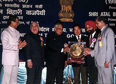 Prime Minister Atal Behari Vajpayee presenting national tourism award to Mr Ashok Pardhan, DG, Tourism, and Mr M.S. Manchanda, Vice-President (Hotel), ITDC, in New Delhi on Monday