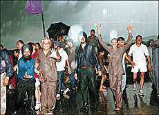 These "shramdanis" are all cheers at the closing ceremony of Shramdan-99 is interrupted by intermittent showers at Sukhna Lake on Thursday