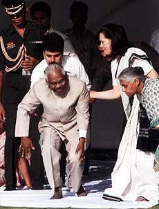 President K. R. Narayanan is helped by Congress President Sonia Gandhi after a prayer meeting held to pay homage to Babu Jagjivan Ram on his death anniversary at Samta Sthal in New Delhi on Tuesday