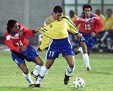 Chile's Roberto Cartes grabs Brazil's Alex from his shirt during an America's Cup Group B game in Ciudad del Este, Paraguay, on Tuesday 