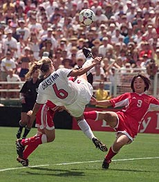 United States' Brandi Chastain (6) jumps high to defend China's Wen Sun's attempt at a shot-on-goal during the first period of overtime in the Women's World Cup Final at the Rose Bowl in Pasadena, California, Saturday 