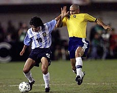 Argentina's Ariel Ortega (left) pushes away Brazil's Ronaldo during an America's Cup quarterfinal game in Ciudad del Este on Sunday. Brazil won 2-1 and will play Mexico in the tournament's semifinals 