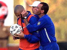 Brazilian striker Ronaldo, gets his ear pulled by the Brazilian national soccer team goalie trainer Paulo Cesar Gusmao after missing a penalty kick during a training session in Foz do Iguazu, Brazil on Tuesday
