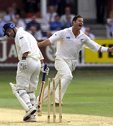New Zealand's Chris Cairns (right) celebrates his dismissal for 7 of England's acting captain Graham Thorpe (left) looking down at his broken wicket, during England's second innings of the 2nd Test Match at Lord's cricket ground in London, Saturday