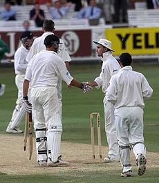 New Zealand captain Stephen Fleming is congratulated by England's acting captain Graham Thorpe (right center) with England's wicket keeper Chris Read (foreground) looking on, after New Zealand's historic win at the Lords cricket ground in London on Sunday