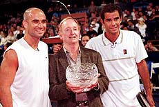 Tennis greats Andre Agassi (left) Rod Laver and Pete Sampras pause for the photographers after Laver was presented a silver bowl for his tennis career before a benefit tennis match on Monday evening, in the Westwood section of Los Angeles