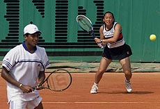 Ai Sugiyama of Japan (right) returns a backhand past her teammate Mahesh Bhupathi of India during their doubles tennis match at the French Open at Roland Garros stadium in Paris on Monday 